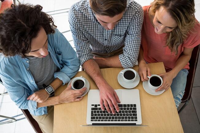 People writing on the computer with coffee